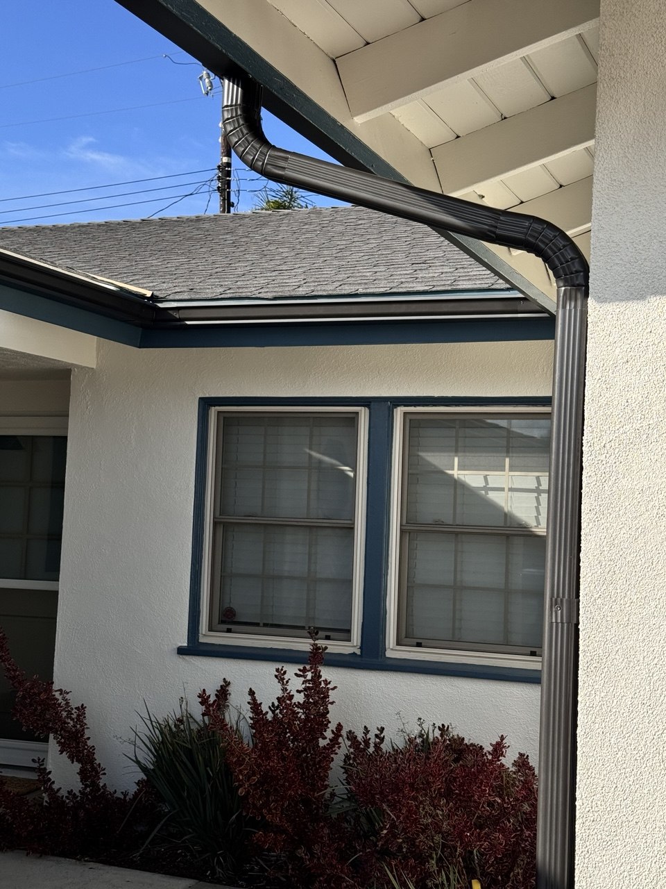 Graphite seamless gutter and downspout on blue trim home - Flashpoint Builders Pasadena