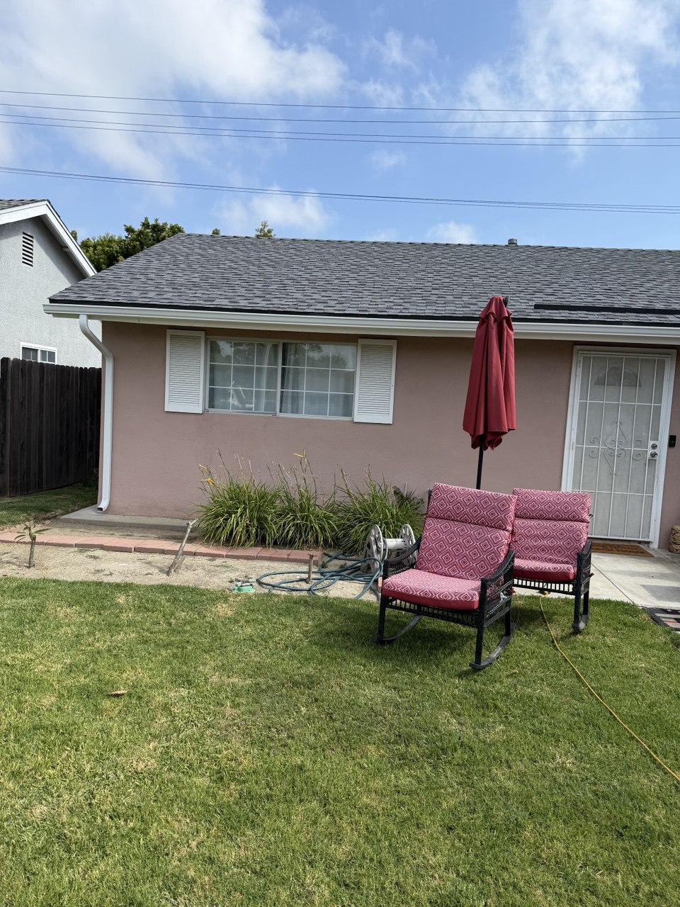 New gray shingle roof with seamless gutter and downspout installation - Flashpoint Builders