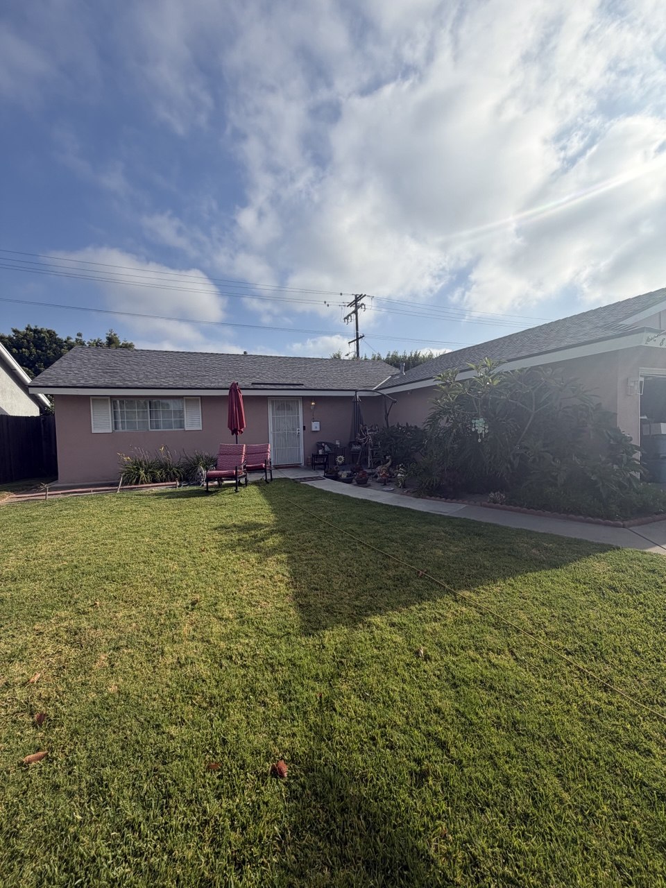Complete shingle roof replacement on pink stucco California home - Flashpoint Builders